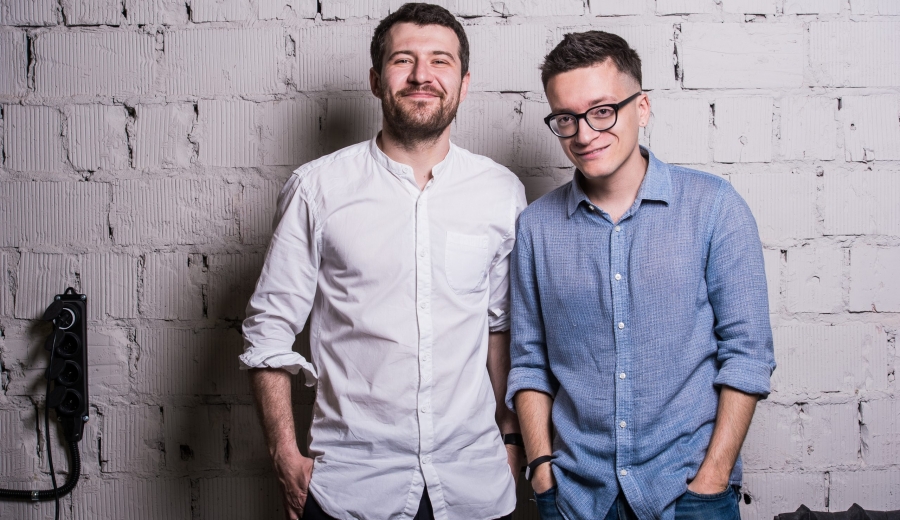 Two young men startupers over grey brick wall loft | web development las vegas